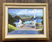 Load image into Gallery viewer, View from the hill down to the sea on a sunny day, with trees casting shadows, and clouds cooling the sky. Framed image.
