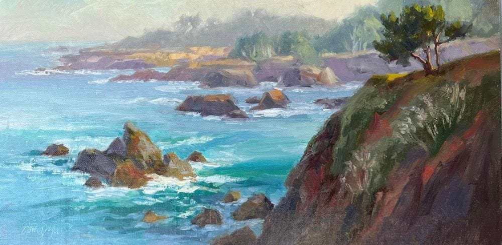 Ocean cove with rocky islands in a blue-green sea on a misty afternoon on the Mendocino Coast