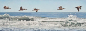 Five brown pelicans flying in formation above the breaking waves, pale blue sky and deeper blue ocean with white and gray toned waves