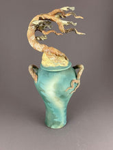 Load image into Gallery viewer, Tall ginger jar with lid. Cypress tree tops the lid with tree branch handles on a soft teal and green jar.