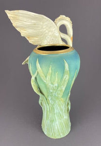 back side of vase, a glorious heron with wings ready to fly on a tall vase adorned with reeds