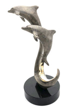 Load image into Gallery viewer, Bronze dolphins swimming in harmony forever and ever, grey crackle patina, black granite base
