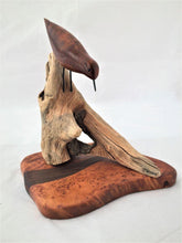 Load image into Gallery viewer, Shorebird of redwood burl facing down a perch of driftwood set on an inlaid redwood burl with a wenge wave through the base.