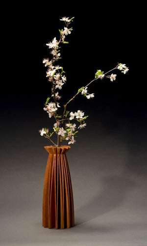Poppy vase of cherry wood, one piece of wood, cut and opened up to create a graceful form. With glass tube for water and flowers