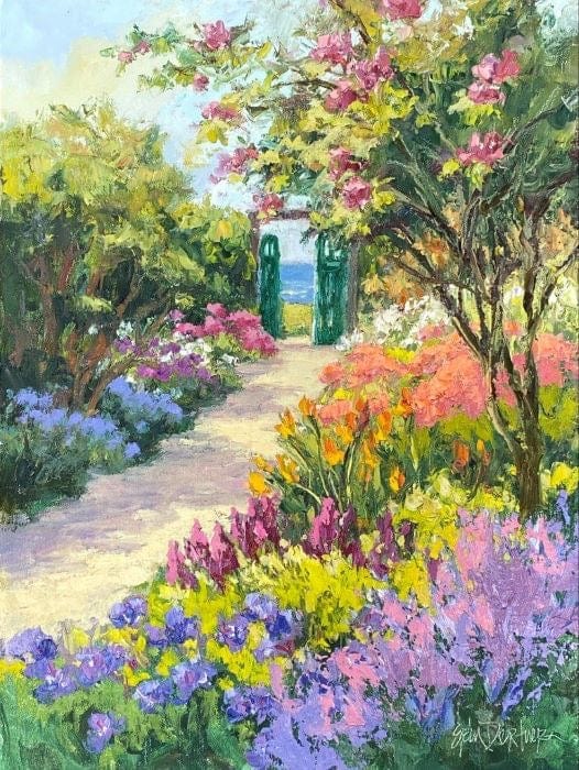 Garden path leading to gates and the sea, colorful spring flowers lining the path 