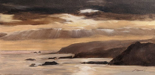 Black clouds and golden evening light on a silvery sea