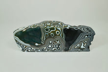 Load image into Gallery viewer,  Earth 13, kiln formed glass sculpture, 11.25 inches long by 4 inches high by 2.25 inches deep.  This beautiful piece is black, white and olive. 
