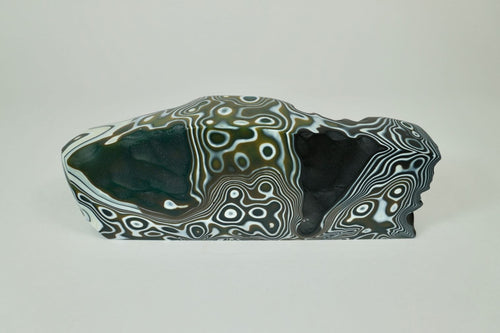  Earth 13, kiln formed glass sculpture, 11.25 inches long by 4 inches high by 2.25 inches deep.  This beautiful piece is black, white and olive. 