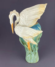 Load image into Gallery viewer, Glorious heron with wings ready to fly on a tall vase adorned with reeds
