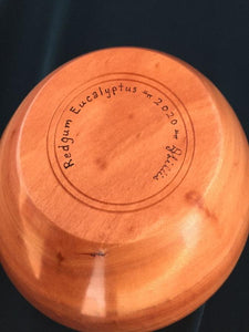 view of bottom shows signature, identity of wood and date.