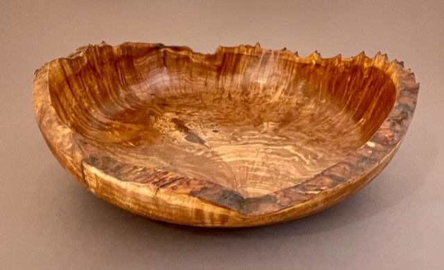 Natural edge madrone burl bowl in striped warm golden to red tones
