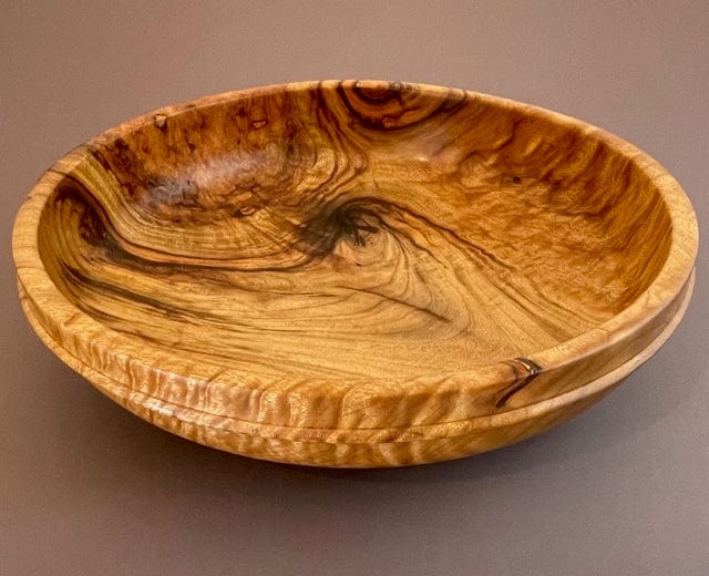 wide turned camphor wood bowl in rich, swirled gold and brown colors