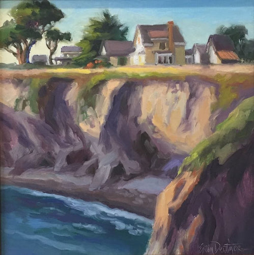 soft light on the headlands and the beach below, with charming homes and ancient trees above