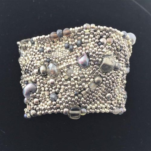 textural beaded cuff bracelet in silver and irridecent blues front view