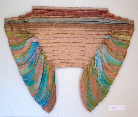 Metallic fibers with rayon, golds, greens and blues, wing shaped, pleated center
