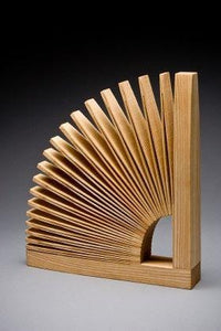 Bookend made from one piece of wood, cut and unfolded to create a fan design. 