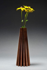 Walnut vase cut from one piece of wood and opened up to create a beautiful form, with glass vial inside for water and flowers