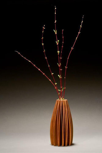 Alder wood vase cut from one piece of wood and opened up to create a flowing form. With glass tube for water and flowers.