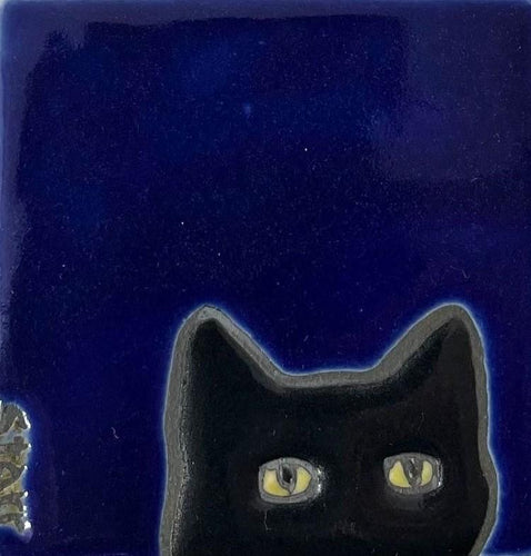 Ceramic tile with a black cat on a colbalt blue background background